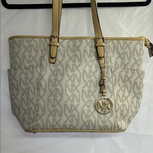 NX Noble Exchange women's large signature logo shoulder bag in cream and tan.
